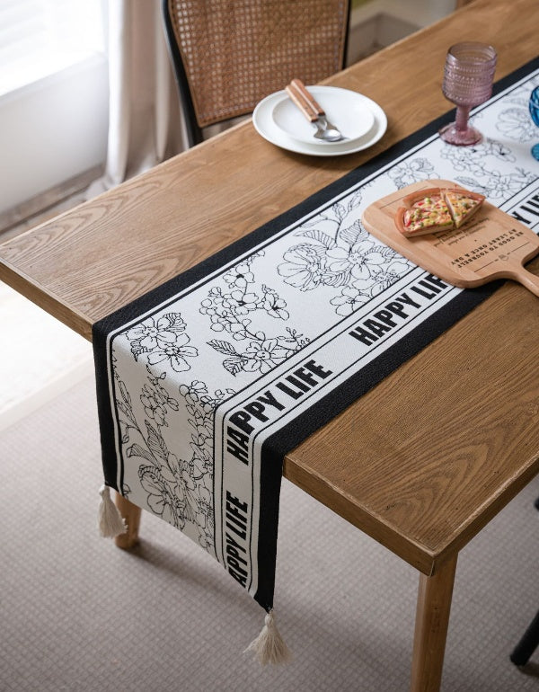 Bandera de mesa con borlas y letras florales en blanco y negro